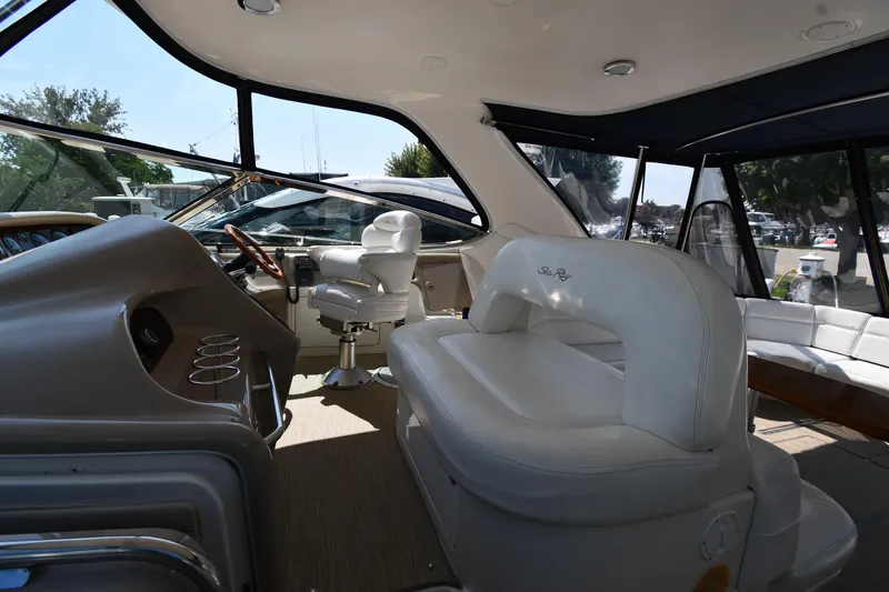Slide: The Image of Interior of 2001 Sea Ray 540 Sundancer yacht with white seating and helm. - 17