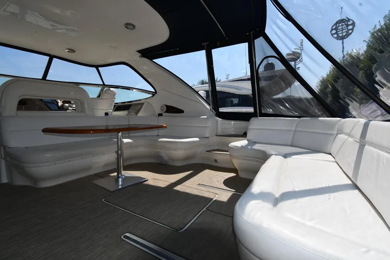 Slide: The Image of Luxurious interior of 2001 Sea Ray 540 Sundancer yacht with white seating and wooden table. - 19