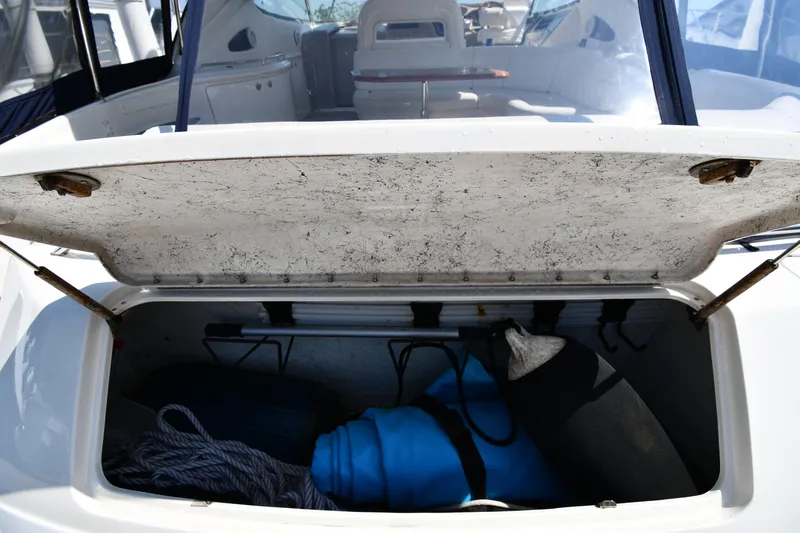 Slide: The Image of Open storage compartment on a 2001 Sea Ray 540 Sundancer boat, showing ropes and equipment. - 25