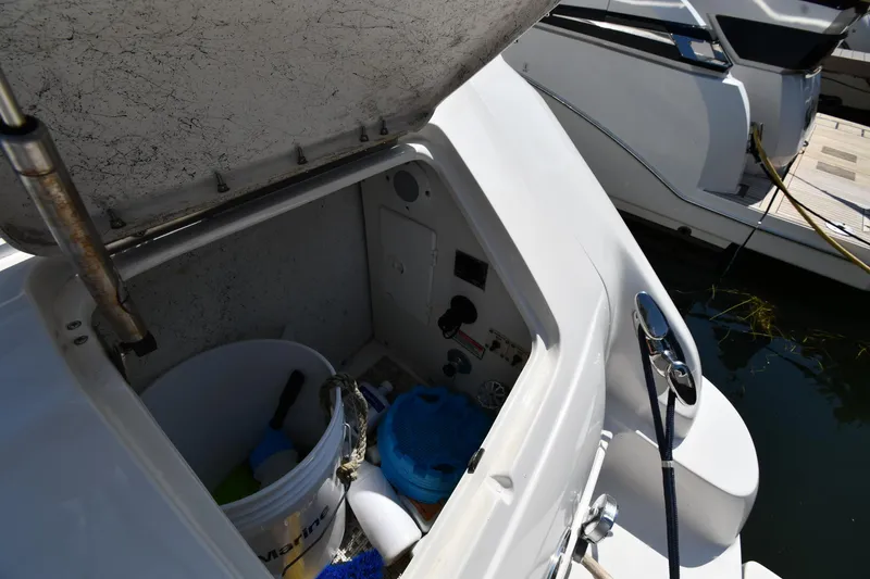 Slide: The Image of Open storage compartment on a 2001 Sea Ray 540 Sundancer boat, docked at a marina. - 26