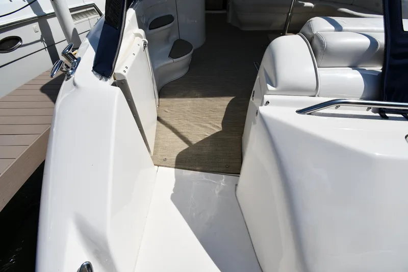 Slide: The Image of 2001 Sea Ray 540 Sundancer boat interior with white seating and carpeted floor. - 27