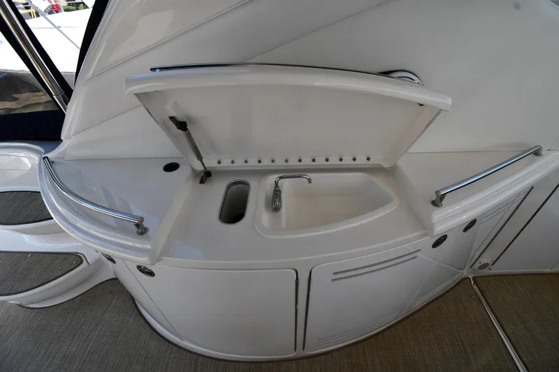 Slide: The Image of 2001 Sea Ray 540 Sundancer yacht kitchenette with sink and storage compartments. - 29