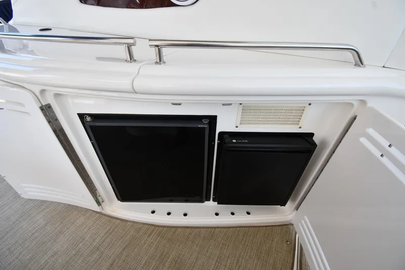 Slide: The Image of 2001 Sea Ray 540 Sundancer yacht interior with built-in mini fridge and storage. - 30