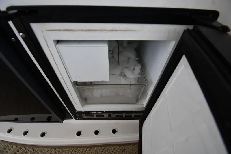Slide: The Image of Ice maker on 2001 Sea Ray 540 Sundancer yacht, open with visible ice cubes. - 32