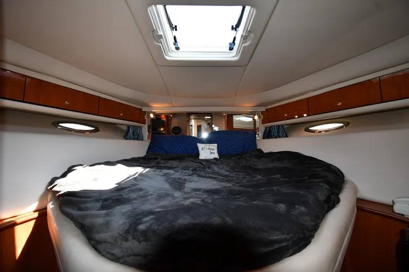 Slide: The Image of Interior cabin of 2001 Sea Ray 540 Sundancer with skylight and cozy bedding. - 35