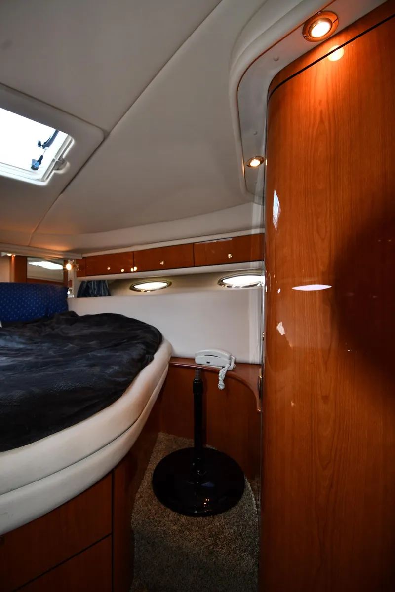 Slide: The Image of Interior cabin of 2001 Sea Ray 540 Sundancer yacht with wood paneling and plush bedding. - 36