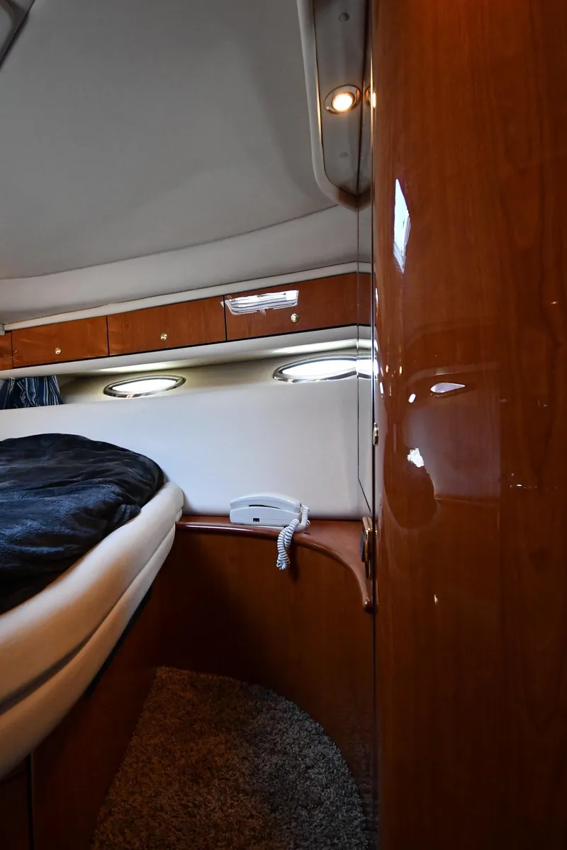 Slide: The Image of Interior cabin of 2001 Sea Ray 540 Sundancer yacht with wood paneling and bed. - 37