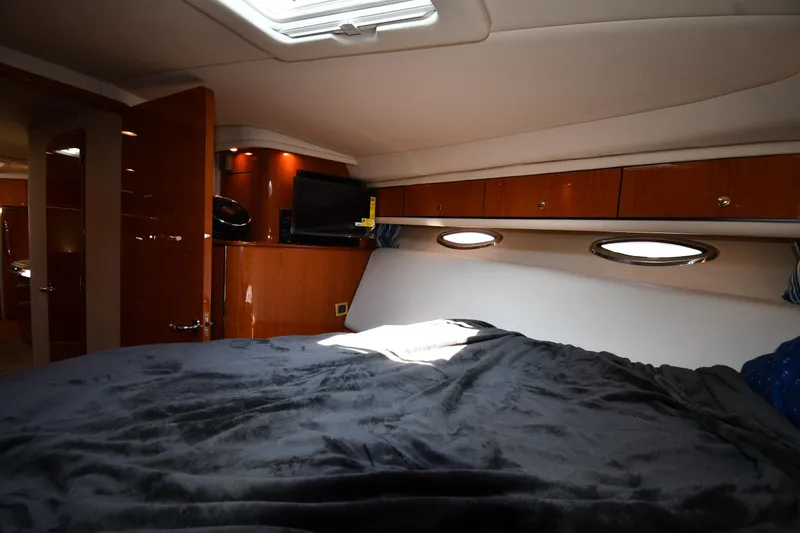 Slide: The Image of Luxurious cabin interior of 2001 Sea Ray 540 Sundancer yacht with bed and portholes. - 39