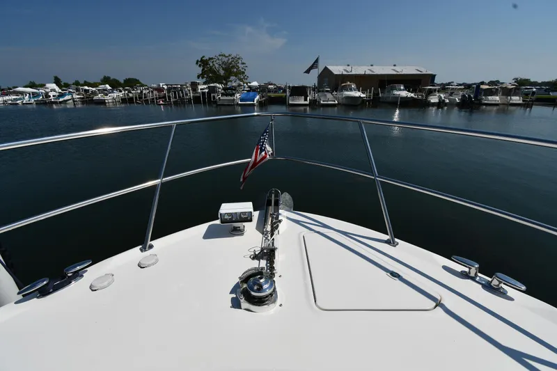 Slide: The Image of Bow view of 2001 Sea Ray 540 Sundancer at marina with American flag. - 4