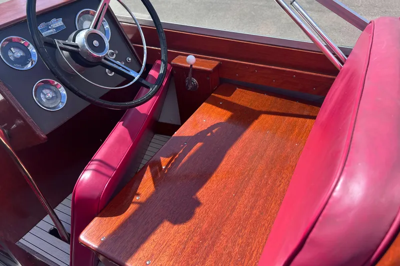 Slide: The Image of 1964 Chris Craft Sea Skiff Sportsman interior with red upholstery and classic steering wheel. - 10
