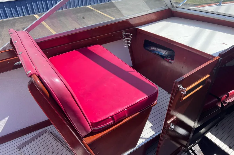 Slide: The Image of 1964 Chris Craft Sea Skiff Sportsman boat interior with red seating and wooden details. - 14