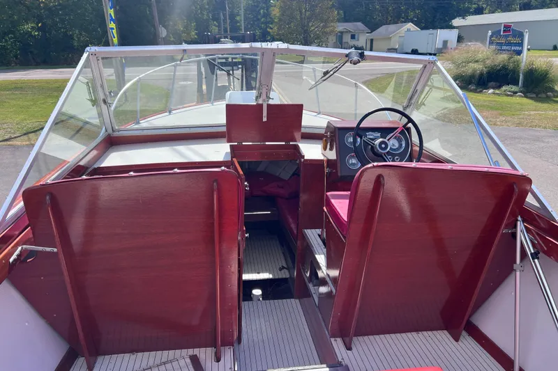 Slide: The Image of 1964 Chris Craft Sea Skiff Sportsman boat interior with wooden seats and steering wheel. - 19