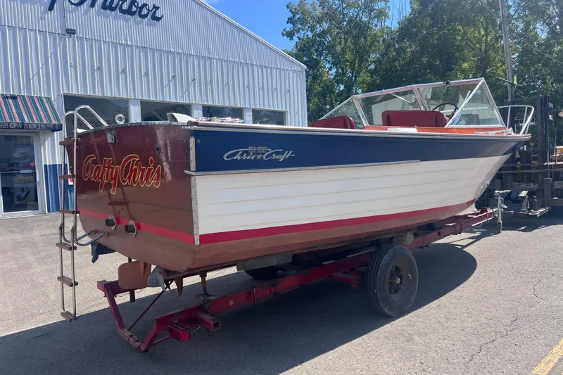 Slide: The Image of 1964 Chris Craft Sea Skiff Sportsman boat on trailer outside a building. - 2