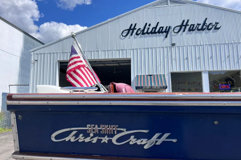 Slide: The Image of 1964 Chris Craft Sea Skiff Sportsman boat at Holiday Harbor with American flag. - 21