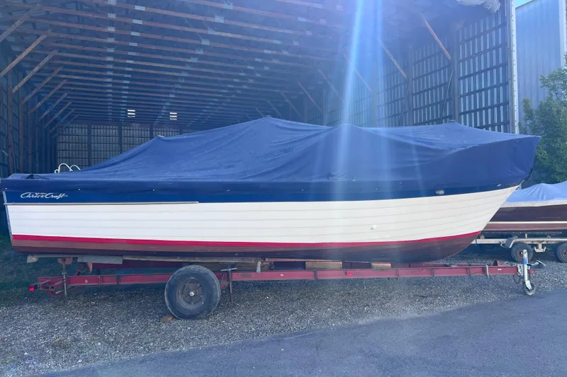 Slide: The Image of 1964 Chris Craft Sea Skiff Sportsman boat covered in storage on a trailer. - 4