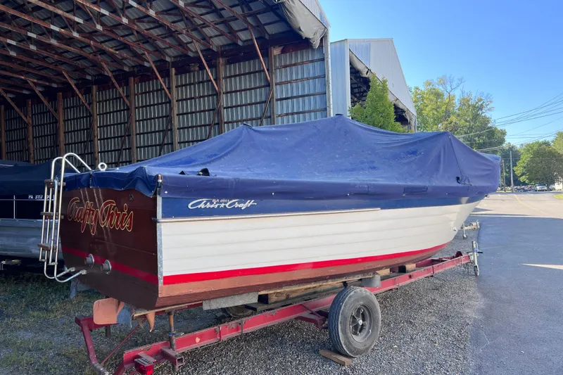 Slide: The Image of 1964 Chris Craft Sea Skiff Sportsman boat on trailer, covered with blue tarp. - 5