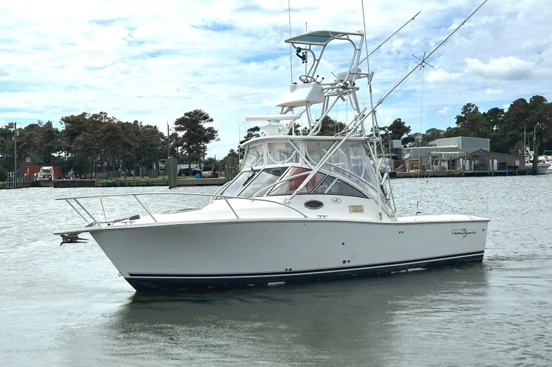 The Image of 2003 Albemarle 27 Express Fisherman boat on calm water, with marina background. - 1
