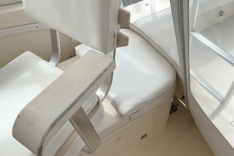 Slide: The Image of Interior seating of 2003 Albemarle 27 Express Fisherman boat, featuring white cushioned seats. - 14