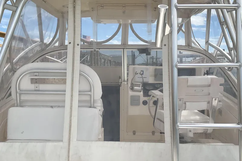 Slide: The Image of 2003 Albemarle 27 Express Fisherman boat interior with helm and seating. - 23