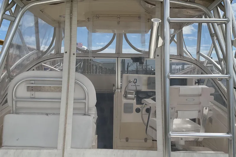 Slide: The Image of 2003 Albemarle 27 Express Fisherman boat interior with helm and seating. - 24
