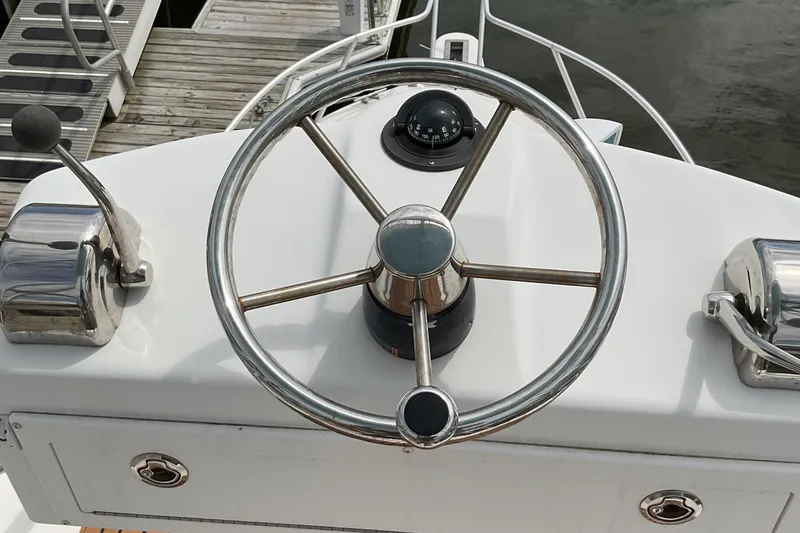 Slide: The Image of Steering wheel of 2003 Albemarle 27 Express Fisherman boat at dock. - 25