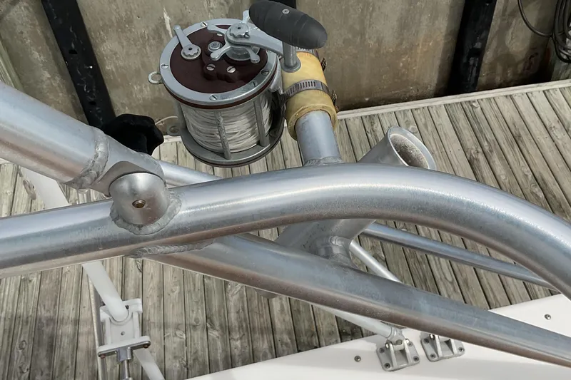 Slide: The Image of Fishing reel on Albemarle 27 Express Fisherman, 2003 model, docked on wooden pier. - 26