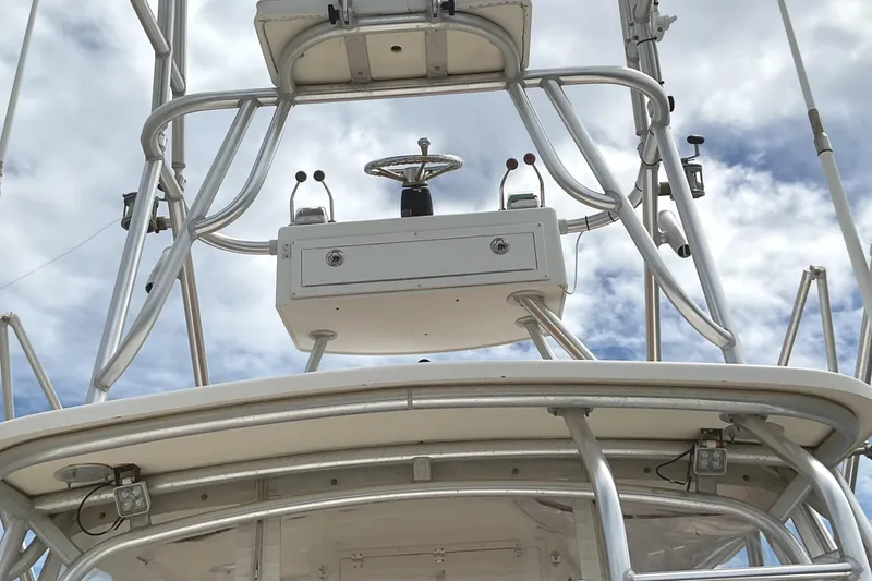 Slide: The Image of 2003 Albemarle 27 Express Fisherman boat tower against cloudy sky. - 28