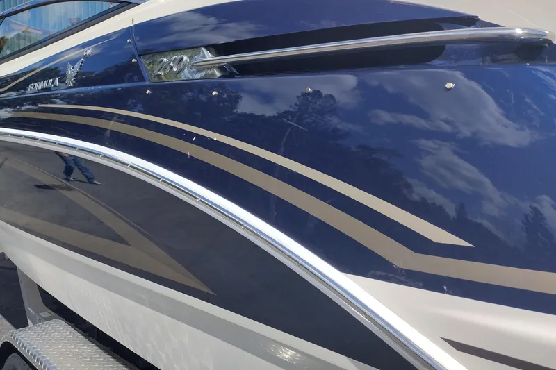 Slide: The Image of Close-up of a 2015 Formula 240 Bowrider boat with sleek blue and beige design. - 10