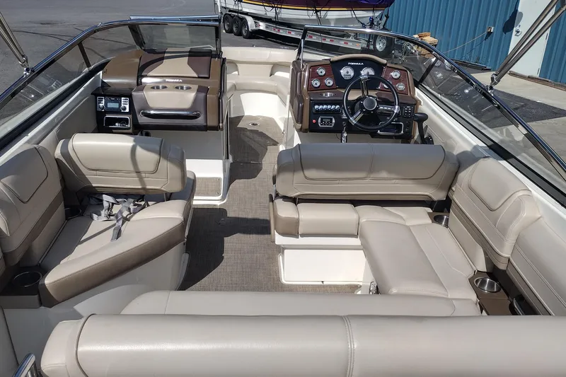 Slide: The Image of 2015 Formula 240 Bowrider interior with beige seating and modern dashboard. - 12