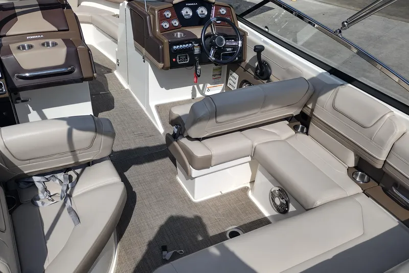 Slide: The Image of Interior of 2015 Formula 240 Bowrider boat with beige seating and modern dashboard. - 13