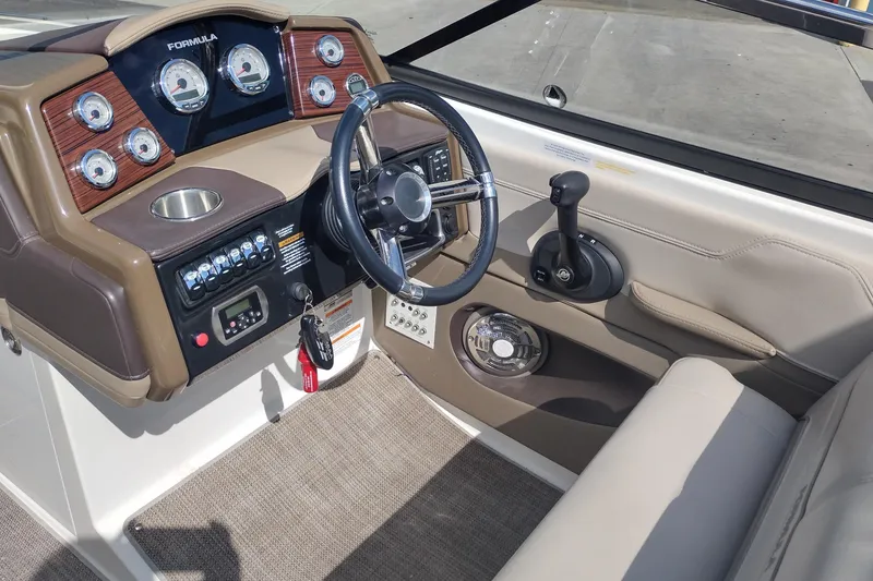 Slide: The Image of 2015 Formula 240 Bowrider dashboard with steering wheel and control panel. - 14
