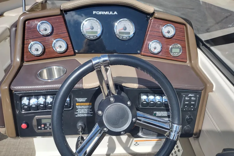 Slide: The Image of Dashboard of a 2015 Formula 240 Bowrider boat with gauges and steering wheel. - 15