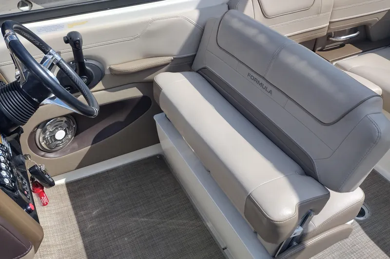 Slide: The Image of 2015 Formula 240 Bowrider interior with steering wheel and beige seating. - 16