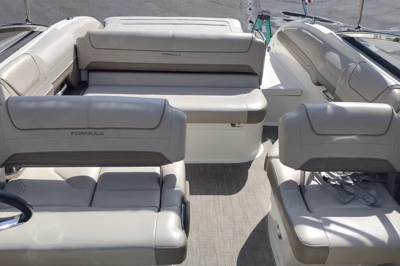 Slide: The Image of 2015 Formula 240 Bowrider interior with beige seating and spacious layout. - 19