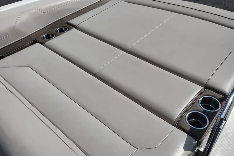 Slide: The Image of 2015 Formula 240 Bowrider boat with beige cushioned seating and built-in cup holders. - 27