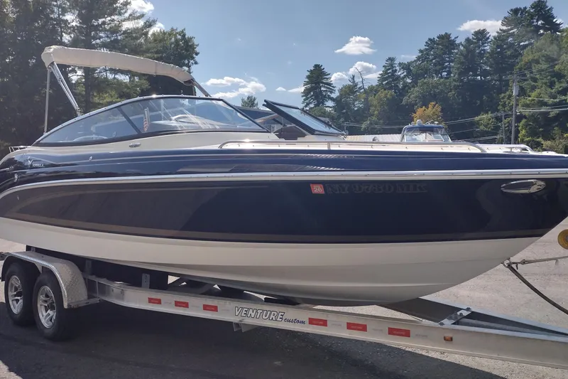 Slide: The Image of 2015 Formula 240 Bowrider boat on trailer, parked outdoors under clear sky. - 3