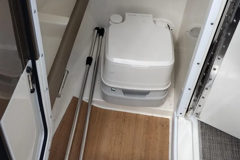 Slide: The Image of Portable toilet in 2015 Formula 240 Bowrider boat interior, with wooden flooring. - 31