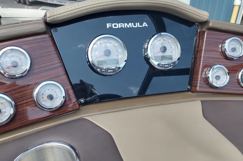 Slide: The Image of Dashboard of 2015 Formula 240 Bowrider with gauges and wood paneling. - 34