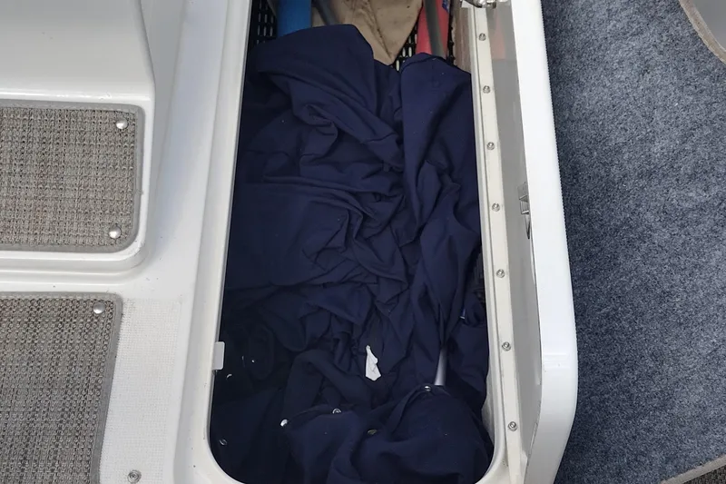 Slide: The Image of Storage compartment in a 2015 Formula 240 Bowrider boat with blue fabric inside. - 37