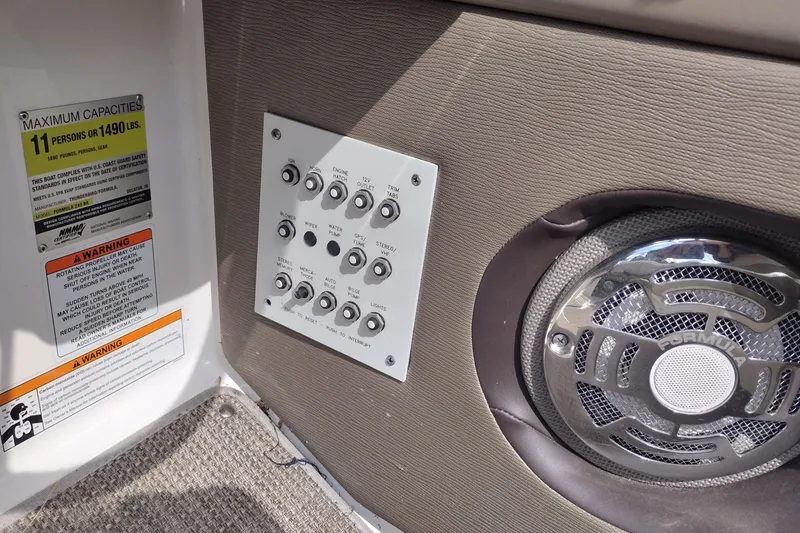 Slide: The Image of Control panel and speaker on 2015 Formula 240 Bowrider boat, with capacity warning label. - 40