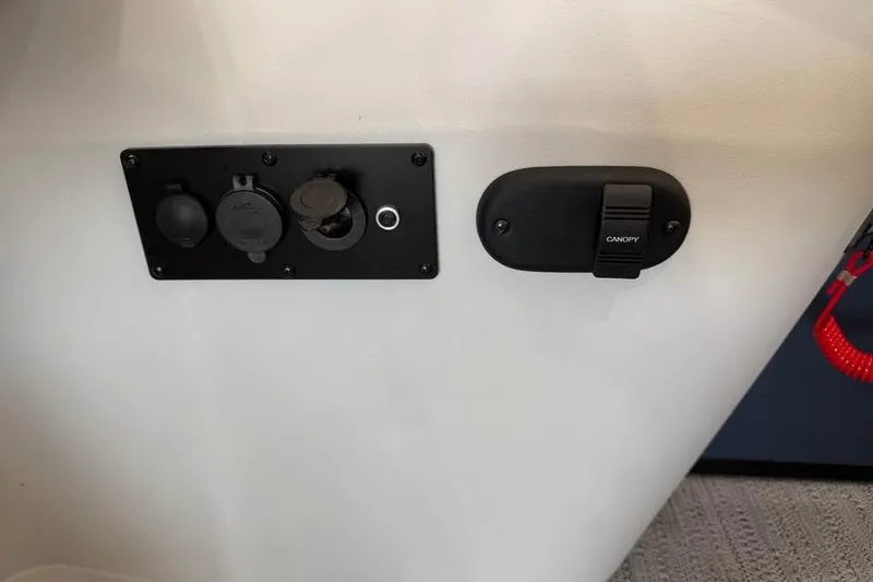 Slide: The Image of Control panel on a 2026 Godfrey Sweetwater 2286 C boat, featuring canopy switch and outlets. - 12