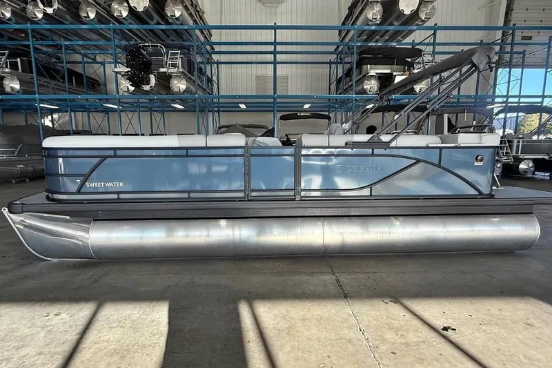 Slide: The Image of 2026 Godfrey Sweetwater 2286 C pontoon boat in a storage facility. - 2