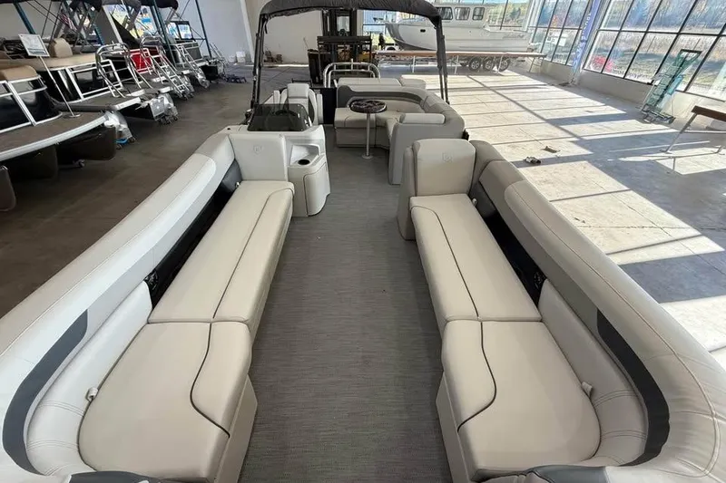 Slide: The Image of 2026 Godfrey Sweetwater 2286 C pontoon boat interior with spacious seating in showroom. - 4