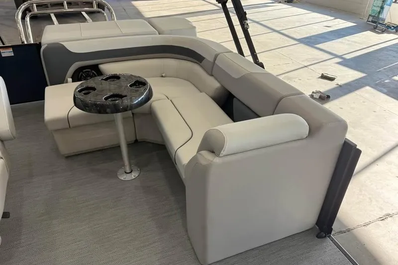 Slide: The Image of Luxurious seating area on 2026 Godfrey Sweetwater 2286 C pontoon boat with cupholder table. - 9