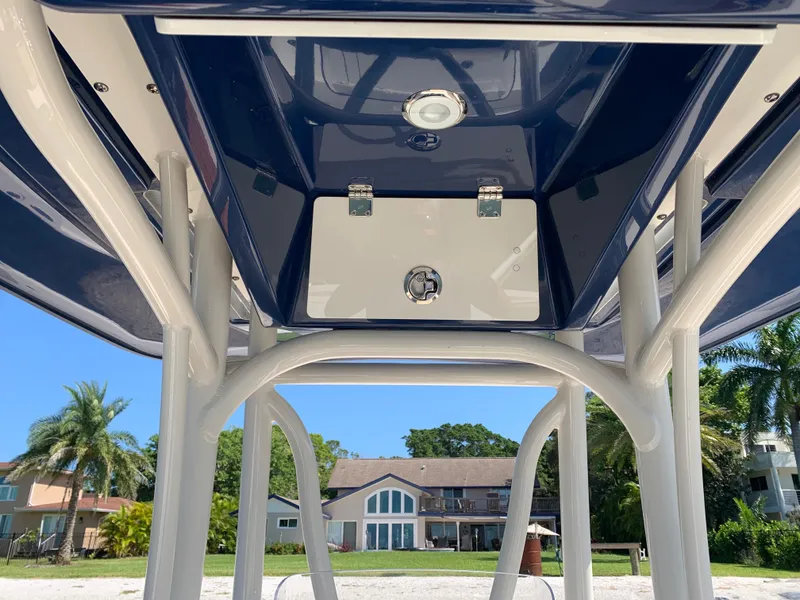 Slide: The Image of 2017 Pathfinder 2500 Hybrid boat with T-top and LED lights against blue sky. - 27