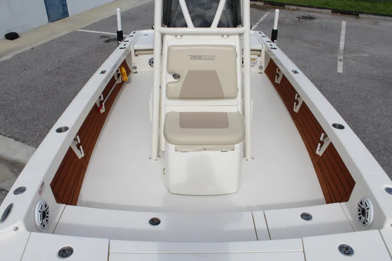 Slide: The Image of 2017 Pathfinder 2500 Hybrid boat interior with beige seating and console. - 30