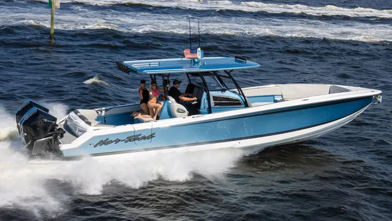 Slide: The Image of 2021 Nor-Tech 390 Sport Center Console boat cruising on the ocean. - 2