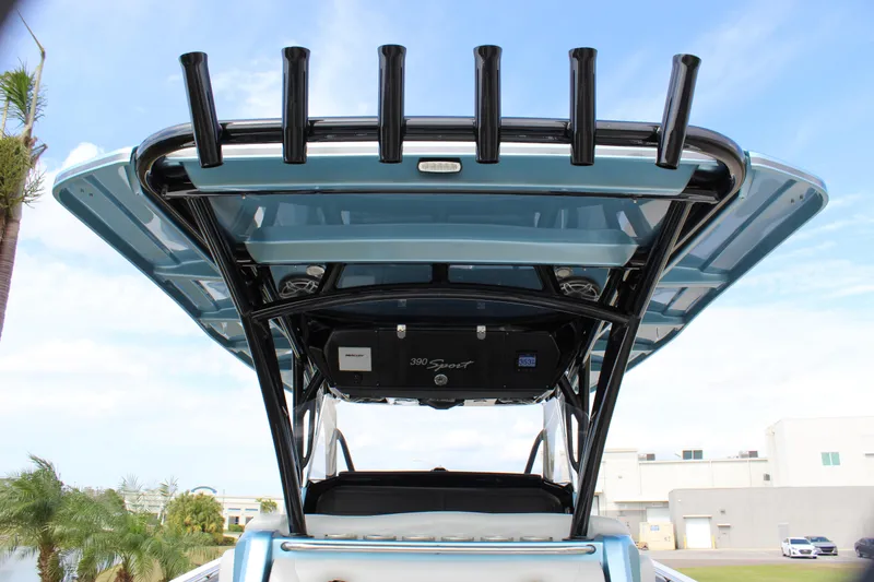 Slide: The Image of 2021 Nor-Tech 390 Sport Center Console boat with rod holders and sleek design. - 31
