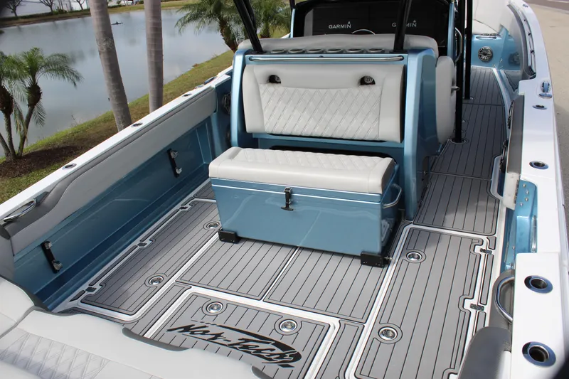Slide: The Image of 2021 Nor-Tech 390 Sport Center Console boat interior with seating and storage, featuring sleek design. - 35