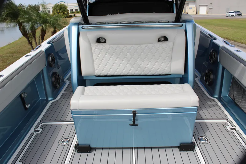Slide: The Image of 2021 Nor-Tech 390 Sport Center Console interior with blue and white seating, modern design. - 36